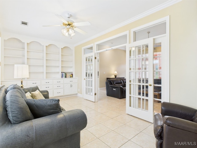 living room with light tile patterned floors, crown molding, visible vents, french doors, and a ceiling fan