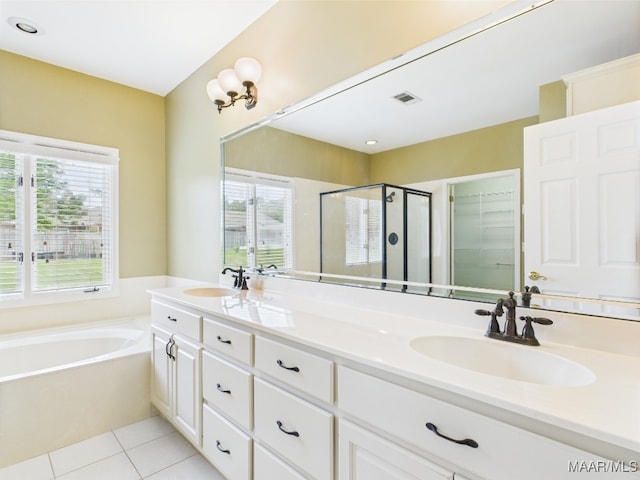 bathroom featuring tile patterned flooring, a sink, a shower stall, and visible vents