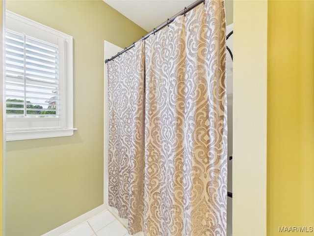 bathroom with baseboards and tile patterned flooring
