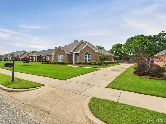 view of front facade with a front lawn, concrete driveway, and brick siding
