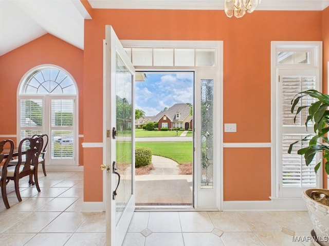 foyer with light tile patterned flooring, vaulted ceiling, a chandelier, and baseboards