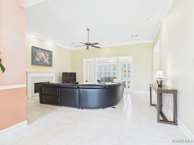 living area featuring light tile patterned floors, ceiling fan, baseboards, and a fireplace