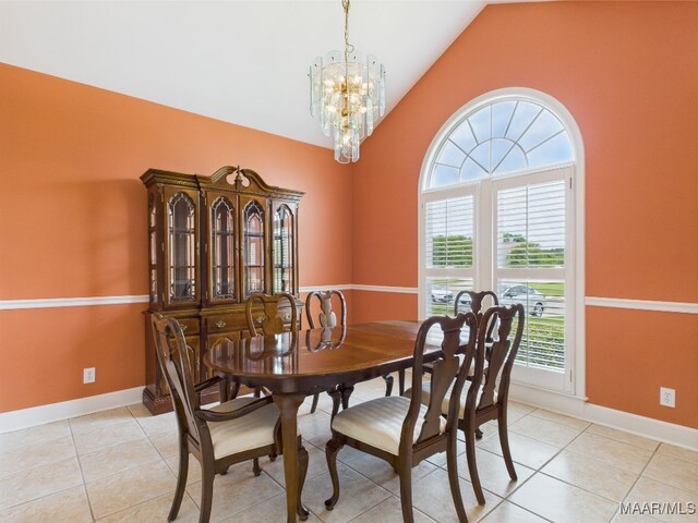 dining room featuring baseboards, high vaulted ceiling, light tile patterned floors, and an inviting chandelier