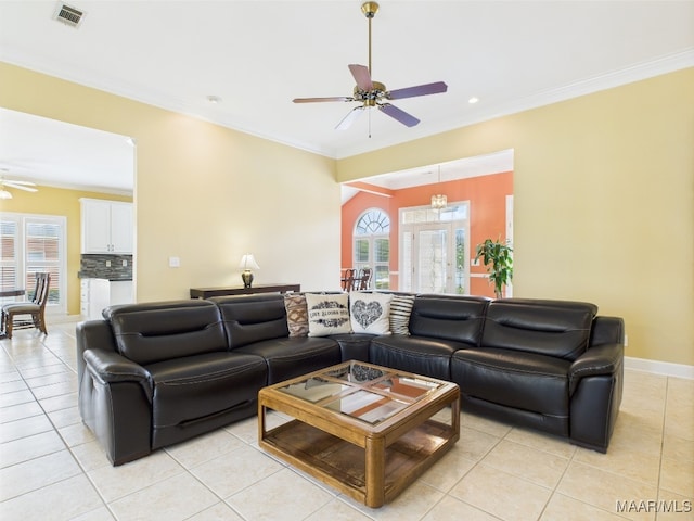 living room featuring light tile patterned floors, crown molding, ceiling fan, and visible vents