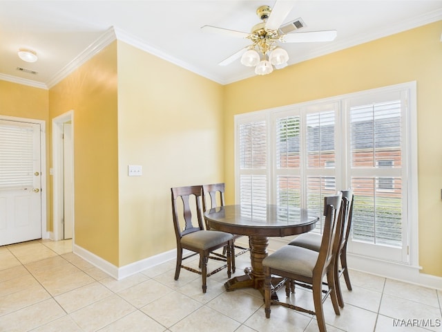 dining area with crown molding, light tile patterned floors, ceiling fan, and baseboards