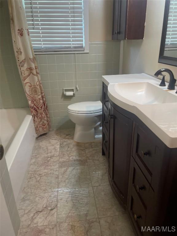 3244 Cheltenham Dr, Montgomery, AL 36116 - bathroom with shower / bath combo, toilet, tile walls, vanity, and marble finish floor
