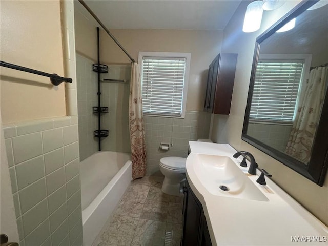 3244 Cheltenham Dr, Montgomery, AL 36116 - full bathroom with a wainscoted wall, shower / tub combo with curtain, toilet, tile walls, and vanity