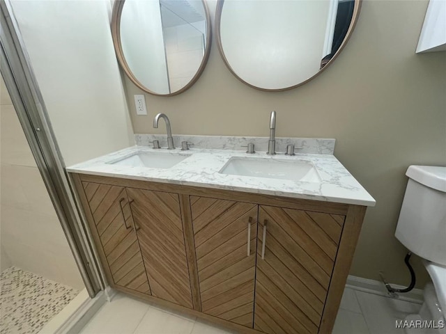 3244 Cheltenham Dr, Montgomery, AL 36116 - bathroom featuring tile patterned floors, toilet, double vanity, and a sink