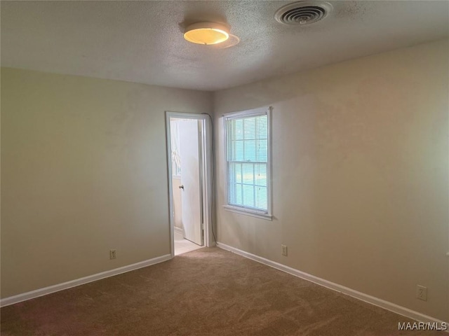 3244 Cheltenham Dr, Montgomery, AL 36116 - empty room featuring baseboards, visible vents, a textured ceiling, and carpet floors