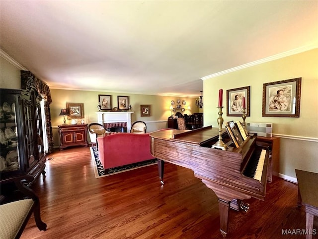 living area featuring ornamental molding, wood finished floors, and a brick fireplace