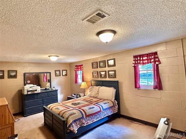 bedroom with visible vents, light carpet, and multiple windows