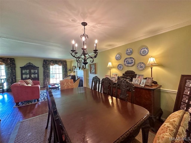 dining room featuring an inviting chandelier, wood finished floors, and ornamental molding