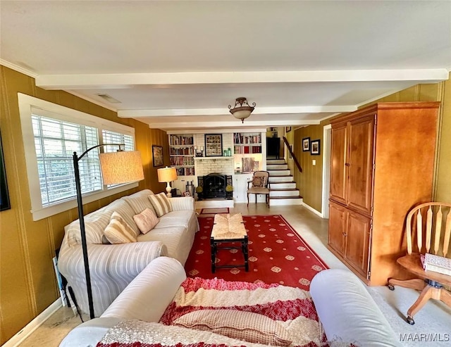 living room featuring beamed ceiling, a fireplace, stairs, visible vents, and baseboards