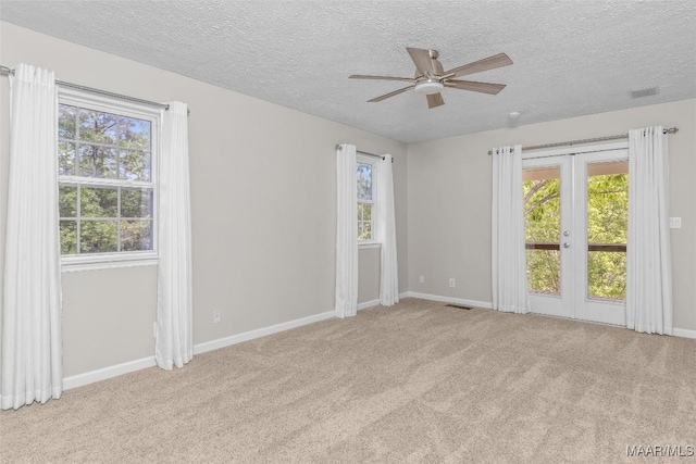 733 Cartwright Rd, Titus, AL 36080 - carpeted empty room featuring a textured ceiling, ceiling fan, and plenty of natural light