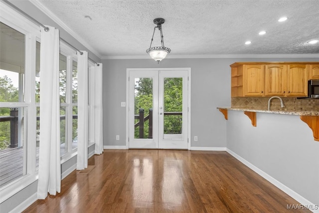 733 Cartwright Rd, Titus, AL 36080 - unfurnished dining area featuring a textured ceiling, ornamental molding, dark wood finished floors, and baseboards
