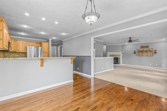 733 Cartwright Rd, Titus, AL 36080 - unfurnished living room with a textured ceiling, light wood-type flooring, recessed lighting, ornamental molding, and a ceiling fan