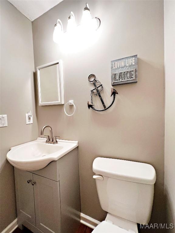 733 Cartwright Rd, Titus, AL 36080 - bathroom featuring baseboards, toilet, and vanity