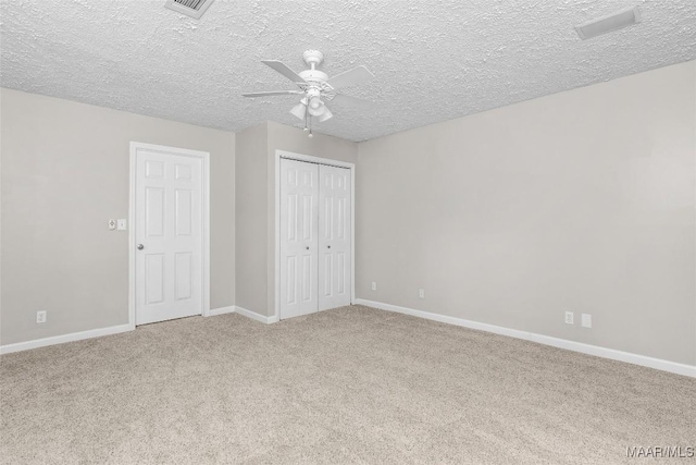 733 Cartwright Rd, Titus, AL 36080 - unfurnished bedroom with a closet, ceiling fan, carpet flooring, baseboards, and a textured ceiling