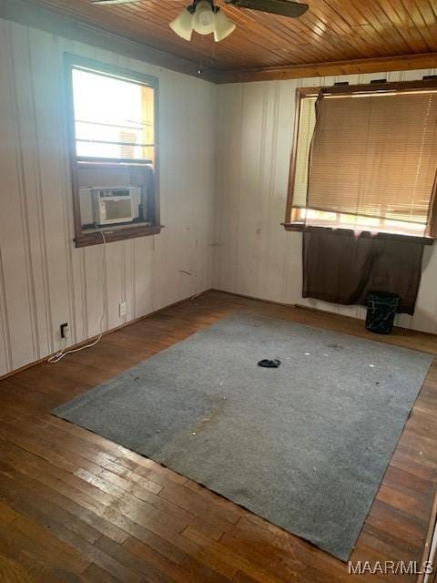 spare room with cooling unit, wooden ceiling, ceiling fan, and hardwood / wood-style flooring