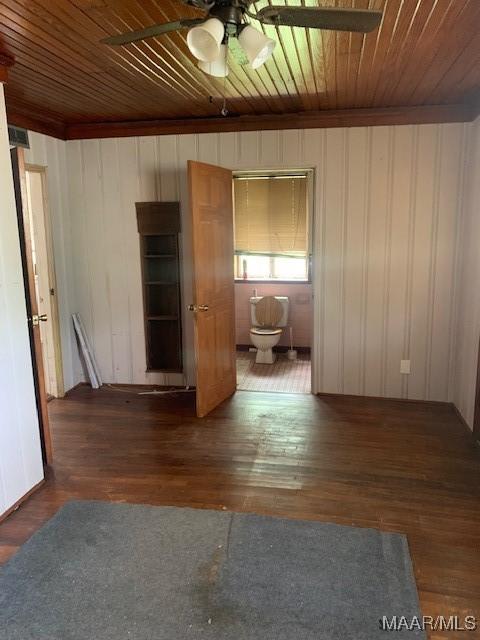 empty room featuring ceiling fan, wood-type flooring, and wood ceiling