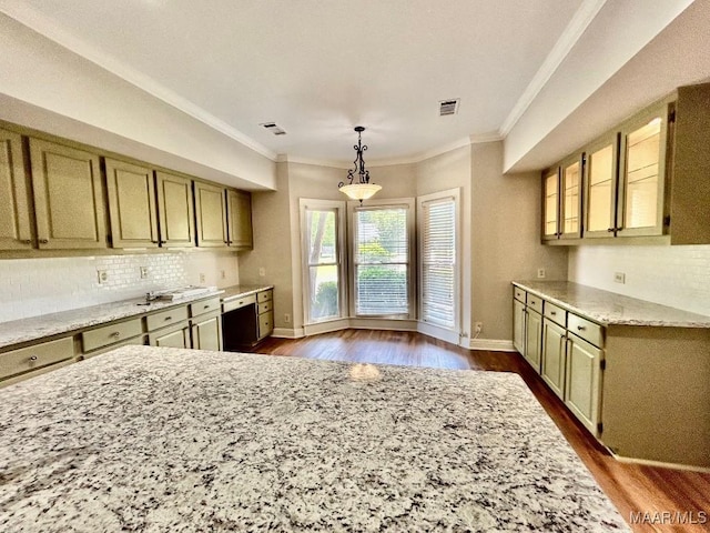 kitchen featuring light stone counters, baseboards, ornamental molding, dark wood finished floors, and backsplash