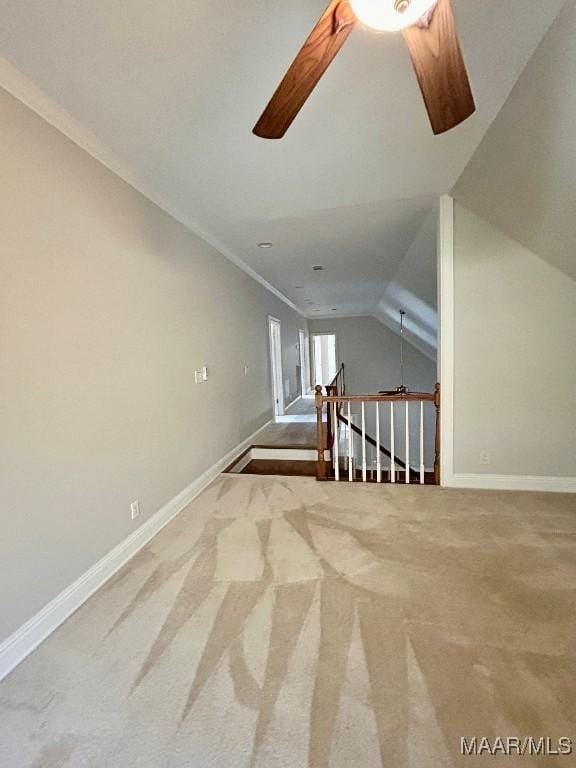 bonus room with a ceiling fan, carpet flooring, vaulted ceiling, and baseboards