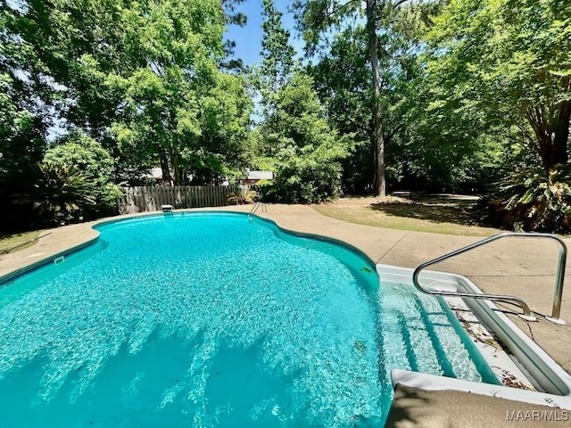 view of swimming pool featuring a fenced in pool, a patio area, and a fenced backyard
