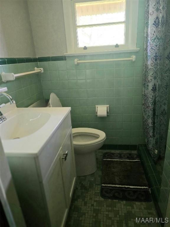 2724 Crestview Ave, Montgomery, AL 36109 - full bath with tile walls, vanity, toilet, a wainscoted wall, and a shower with shower curtain