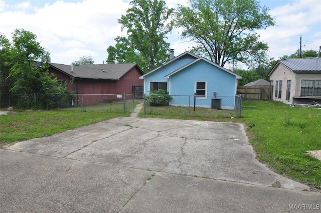view of front of home with a front yard, fence private yard, and a gate