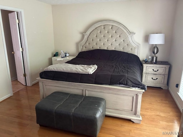 bedroom featuring light wood-type flooring and baseboards