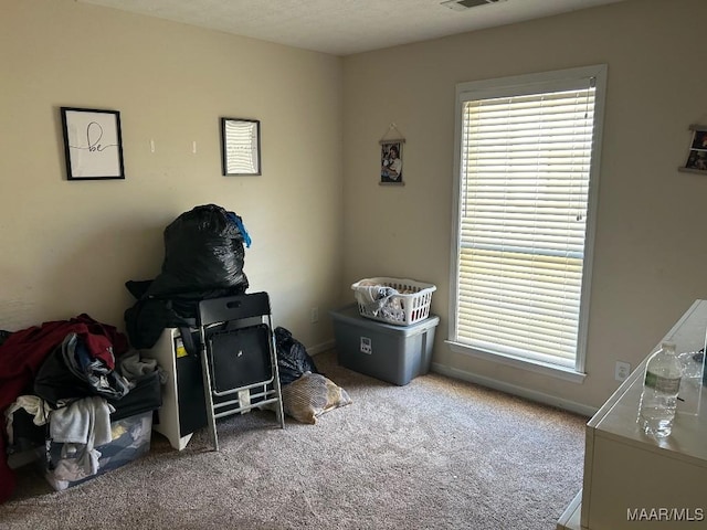 bedroom with visible vents, carpet flooring, and baseboards