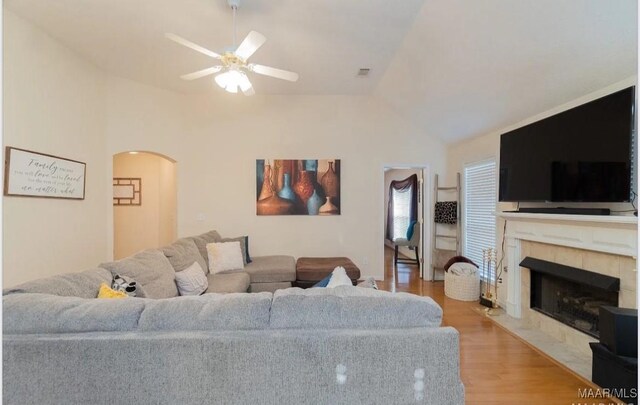 7648 Steele Ridge Dr, Montgomery, AL 36117 - living area featuring ceiling fan, light wood-type flooring, arched walkways, a fireplace, and lofted ceiling