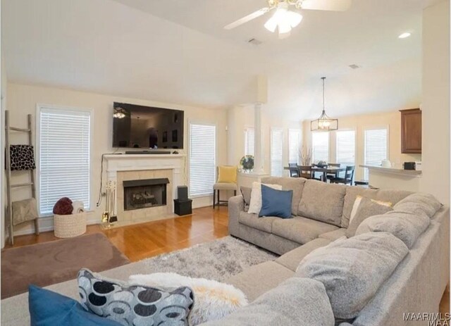 7648 Steele Ridge Dr, Montgomery, AL 36117 - living room featuring a ceiling fan, wood finished floors, a tile fireplace, and lofted ceiling