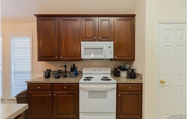 7648 Steele Ridge Dr, Montgomery, AL 36117 - kitchen featuring white appliances, light countertops, and healthy amount of natural light
