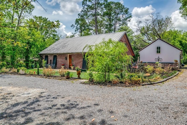 view of front of property with a standing seam roof, a porch, and metal roof