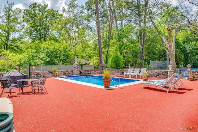 view of pool featuring fence, a grill, a patio, and a fenced in pool