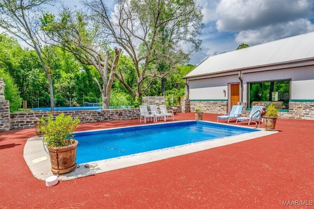 pool with a patio area