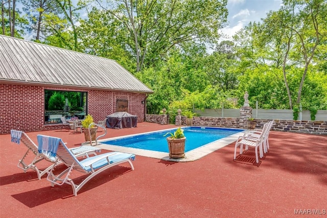 view of pool with area for grilling, a patio, and a fenced in pool