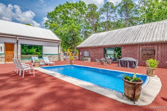 view of swimming pool with a fenced in pool, central AC, grilling area, and a patio area