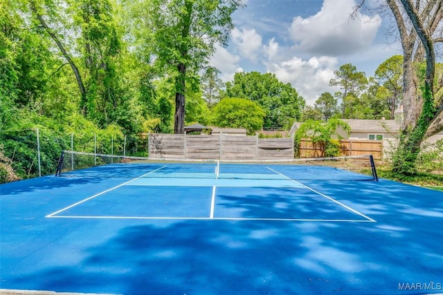 view of sport court featuring fence