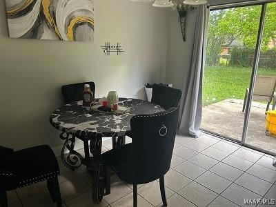 dining space featuring light tile patterned floors