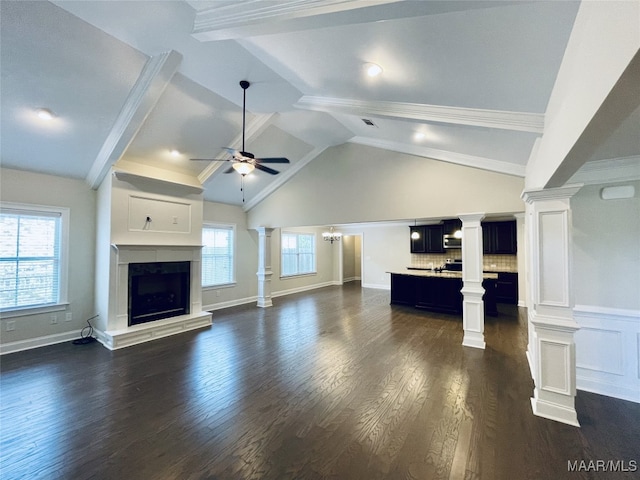 unfurnished living room featuring lofted ceiling with beams, a high end fireplace, dark wood-style flooring, visible vents, and a ceiling fan