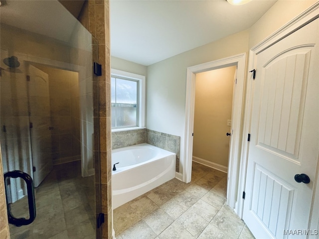 full bathroom featuring a shower stall and a bath