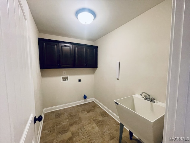 laundry area with electric dryer hookup, cabinet space, washer hookup, a sink, and baseboards