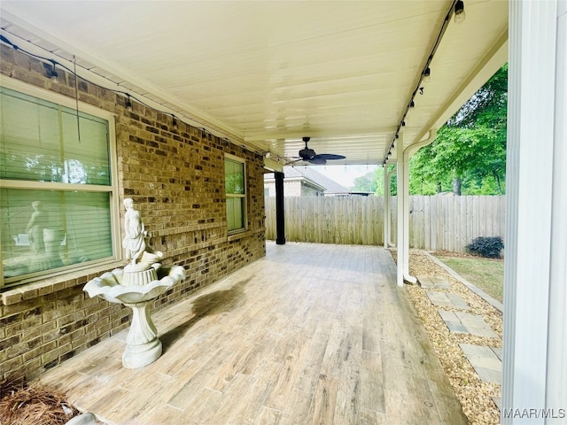 view of patio / terrace featuring fence and ceiling fan