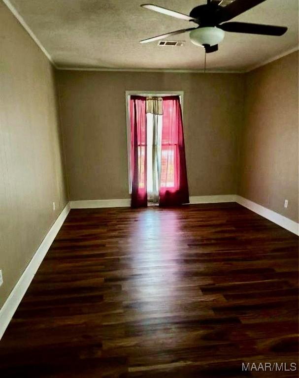 222 Woodbine St, Selma, AL 36701 - empty room featuring wood finished floors, a ceiling fan, and crown molding
