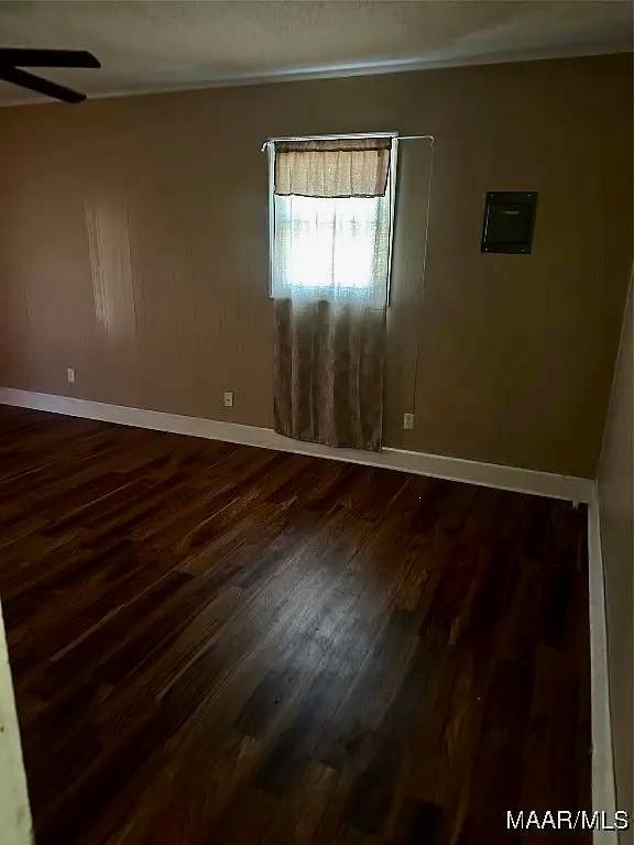 222 Woodbine St, Selma, AL 36701 - spare room featuring dark wood-style floors and ceiling fan