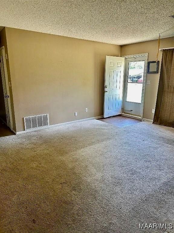 222 Woodbine St, Selma, AL 36701 - spare room with carpet and a textured ceiling
