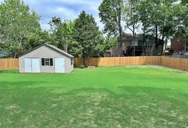 view of yard featuring a fenced backyard, a storage unit, and an outdoor structure