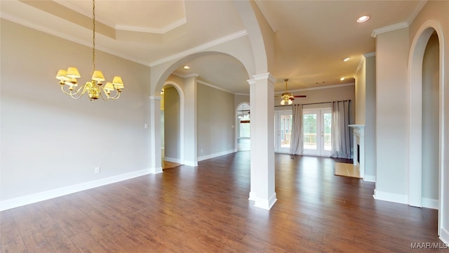 interior space featuring arched walkways, dark wood finished floors, ceiling fan with notable chandelier, recessed lighting, and baseboards